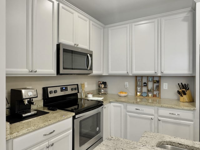 1069 Lexi Ct, Ladson, SC 29456 - kitchen with stainless steel appliances, white cabinets, and light stone countertops