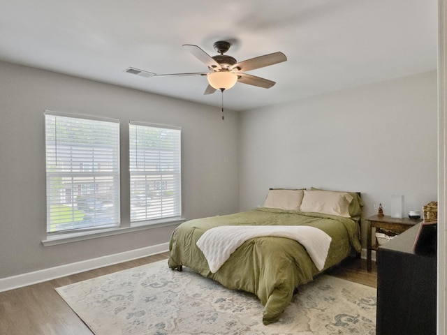 1069 Lexi Ct, Ladson, SC 29456 - bedroom with multiple windows, wood finished floors, and baseboards
