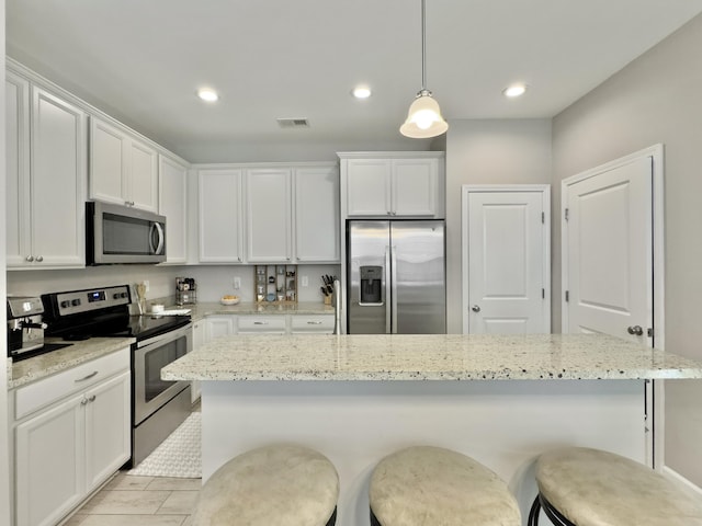 1069 Lexi Ct, Ladson, SC 29456 - kitchen with appliances with stainless steel finishes, white cabinetry, a breakfast bar area, and recessed lighting