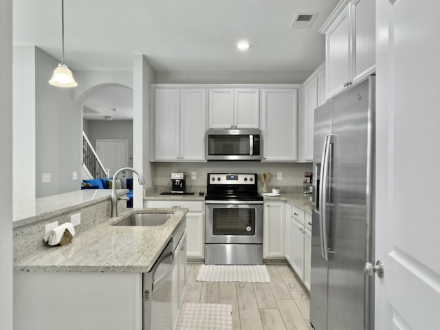 1069 Lexi Ct, Ladson, SC 29456 - kitchen with stainless steel appliances, a sink, white cabinets, and recessed lighting