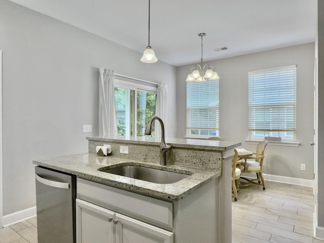 1069 Lexi Ct, Ladson, SC 29456 - kitchen with stainless steel dishwasher, a sink, baseboards, and decorative light fixtures