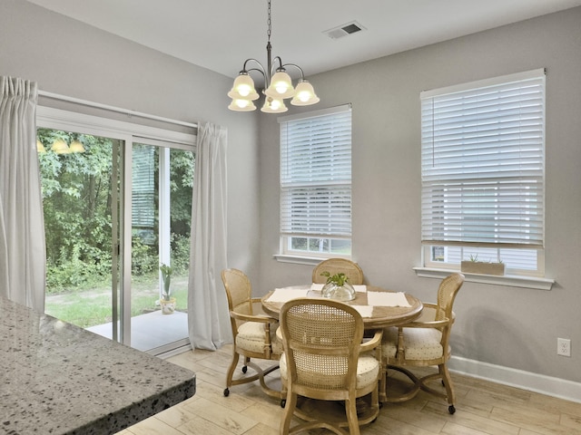 1069 Lexi Ct, Ladson, SC 29456 - dining space with light wood-style flooring, plenty of natural light, and a chandelier