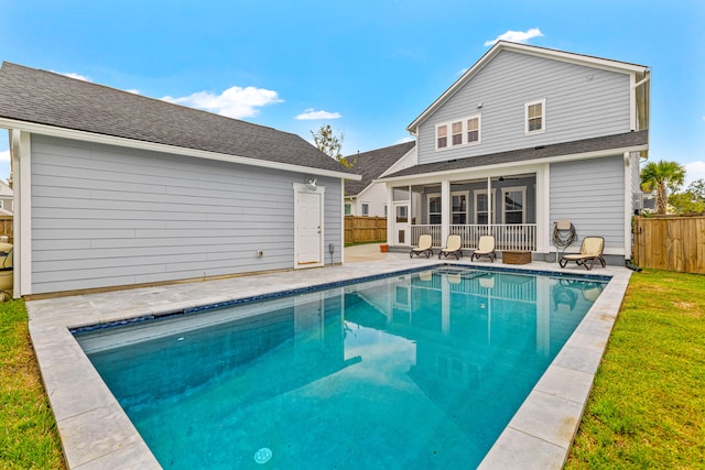 back of house with a patio, a yard, a sunroom, and a fenced in pool