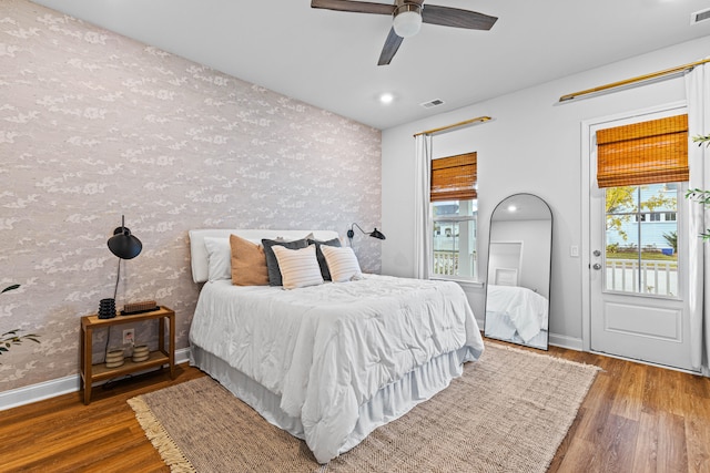 bedroom featuring multiple windows, ceiling fan, and hardwood / wood-style flooring