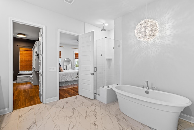 bathroom with hardwood / wood-style flooring, plus walk in shower, and a notable chandelier