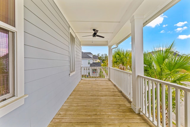 wooden terrace featuring ceiling fan