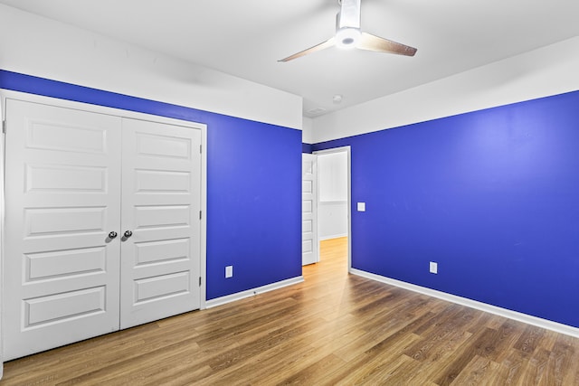 unfurnished bedroom with a closet, ceiling fan, and hardwood / wood-style floors