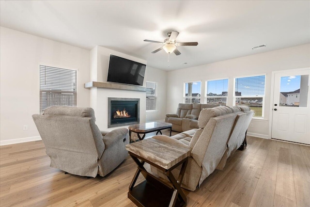 living room with ceiling fan and light hardwood / wood-style floors