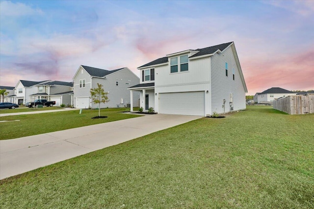 view of front facade featuring a garage and a lawn