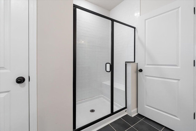 bathroom with tile patterned flooring and an enclosed shower