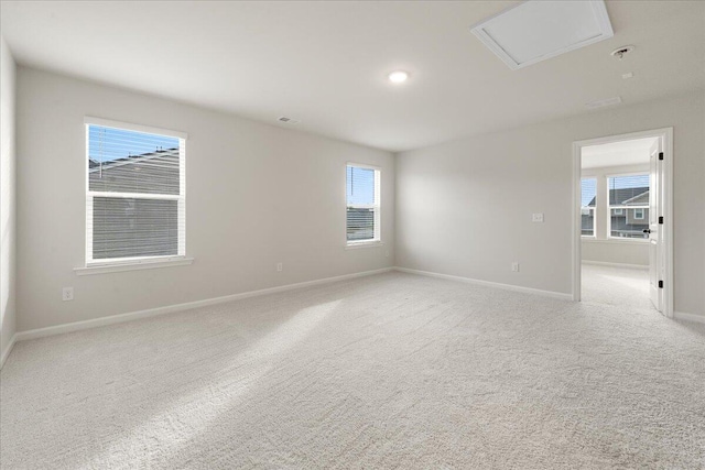 spare room with light colored carpet and a wealth of natural light