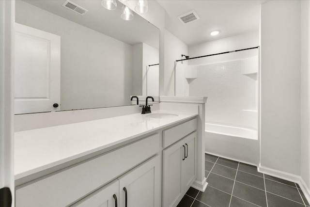 bathroom featuring vanity, tile patterned floors, and tiled shower / bath