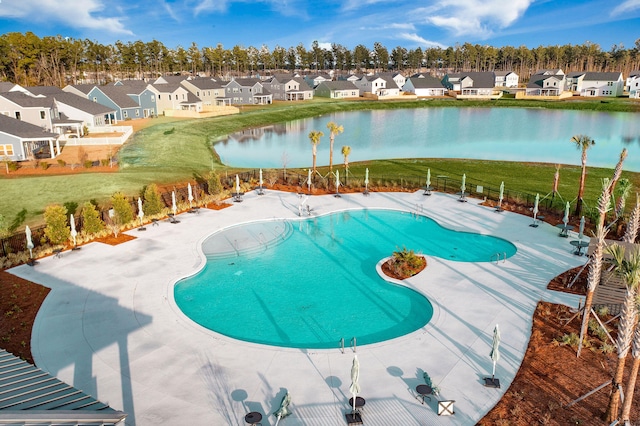 view of swimming pool with a water view and a patio