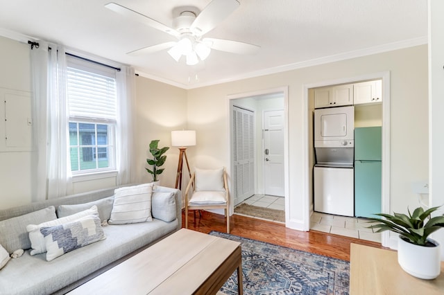 living room with hardwood / wood-style floors, plenty of natural light, and ornamental molding