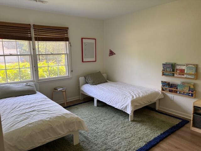 bedroom with baseboards and wood finished floors