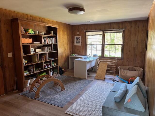 home office featuring wood walls and wood finished floors