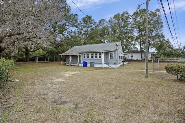 2736 Bonds Ave, North Charleston, SC 29405 - back of house featuring a carport and a lawn