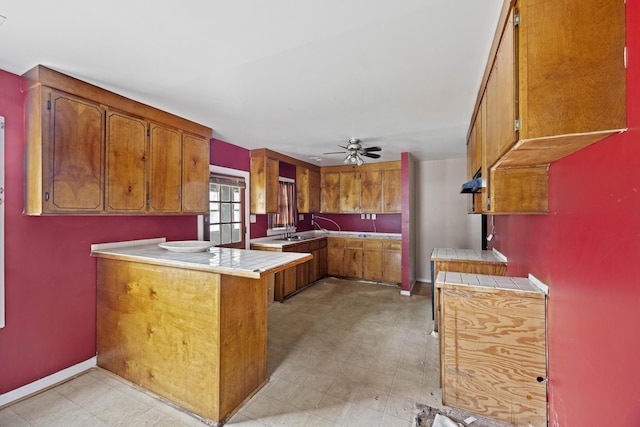 2736 Bonds Ave, North Charleston, SC 29405 - kitchen featuring ceiling fan, kitchen peninsula, sink, and tile counters