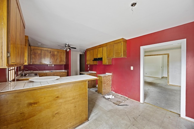 2736 Bonds Ave, North Charleston, SC 29405 - kitchen with tile counters, ceiling fan, sink, and kitchen peninsula