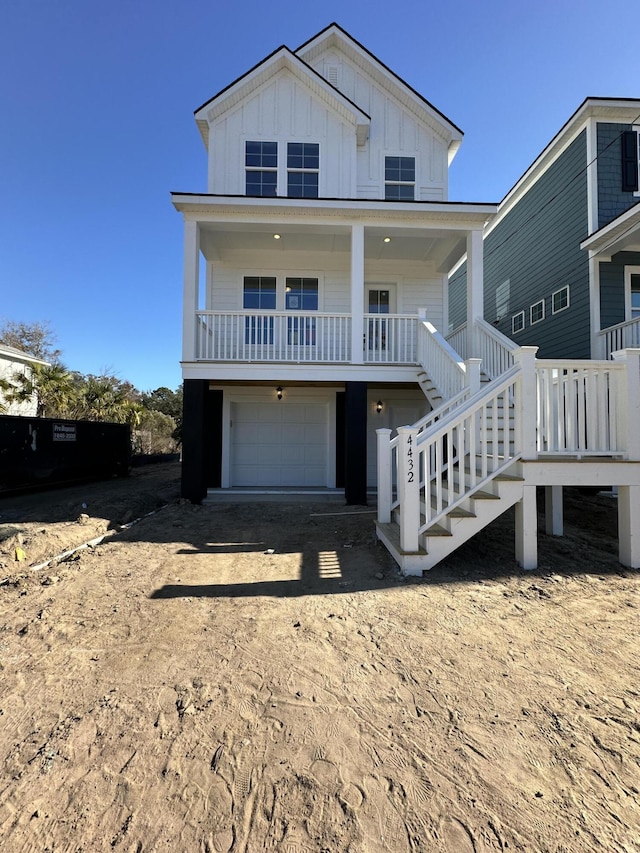 view of front of property with a porch and a garage