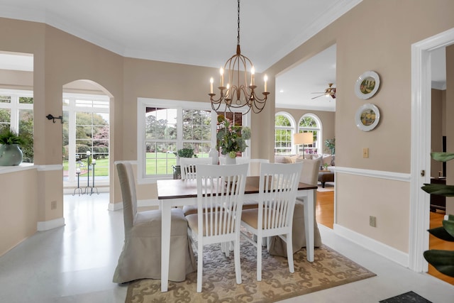 dining space with baseboards, arched walkways, and crown molding
