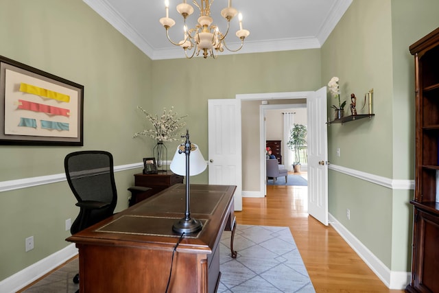 home office with baseboards, light wood-type flooring, ornamental molding, and a chandelier