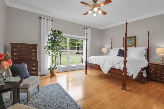 bedroom featuring a ceiling fan, wood finished floors, and crown molding