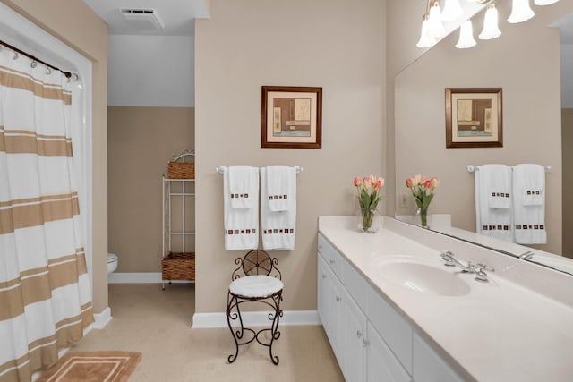 full bathroom with toilet, vanity, baseboards, and visible vents