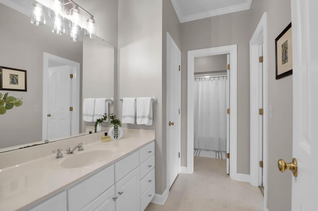 bathroom with baseboards, crown molding, and vanity