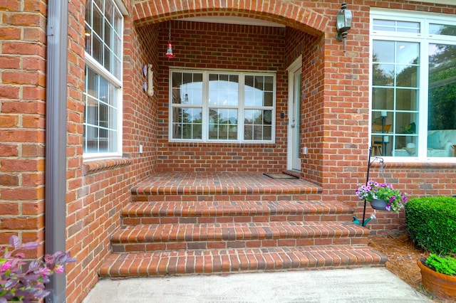 doorway to property with brick siding