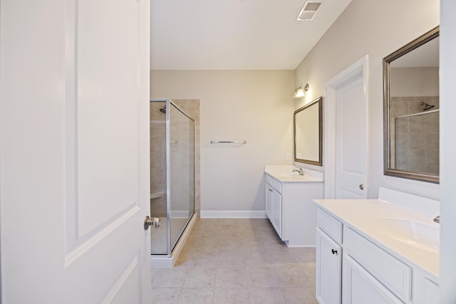 bathroom featuring tile patterned floors, vanity, and a shower with door