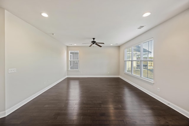 empty room featuring dark hardwood / wood-style flooring and ceiling fan