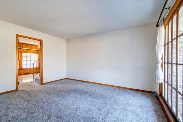 carpeted spare room with a textured ceiling