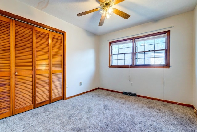 unfurnished bedroom featuring carpet floors, ceiling fan, and a closet