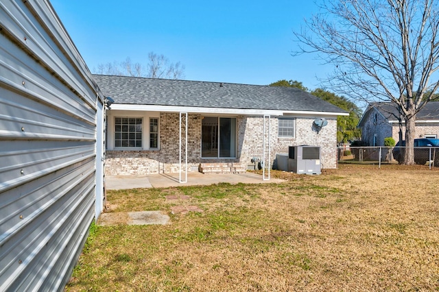 back of house with a patio, a lawn, and central air condition unit