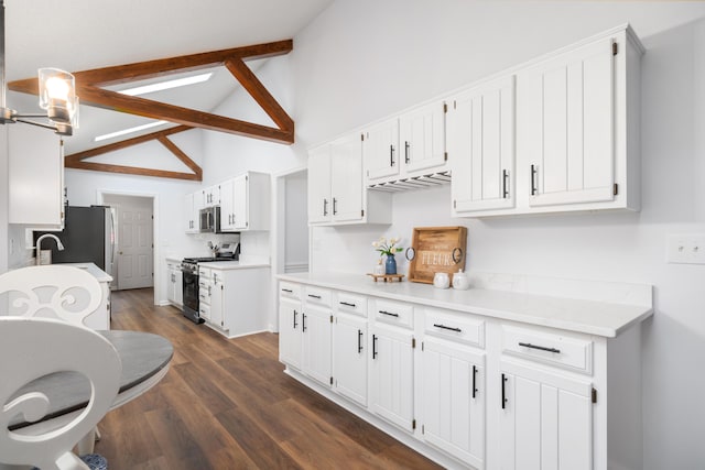 kitchen with appliances with stainless steel finishes, dark hardwood / wood-style flooring, white cabinets, high vaulted ceiling, and beamed ceiling