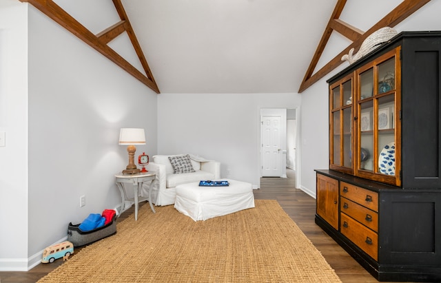 bedroom with vaulted ceiling with beams and dark hardwood / wood-style floors