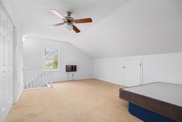 additional living space with ceiling fan, lofted ceiling, light carpet, and heating unit