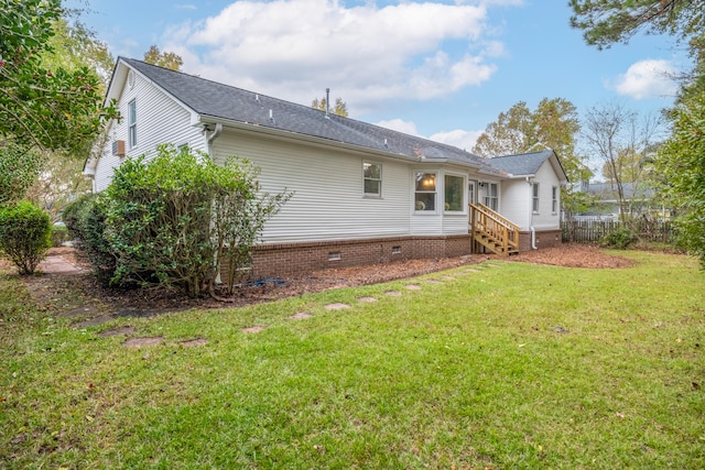 rear view of property featuring a yard