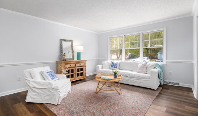 living room with dark hardwood / wood-style flooring, a textured ceiling, and crown molding