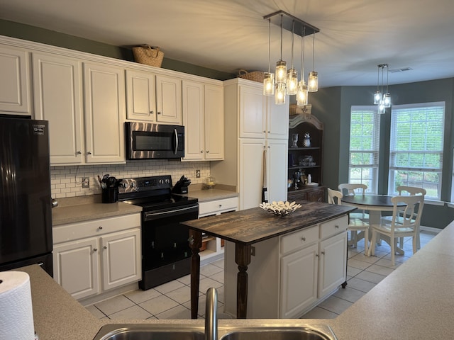 101 Cobblers Glen Ct, Lexington, SC 29072 - kitchen featuring white cabinetry, decorative backsplash, light tile patterned floors, and black appliances