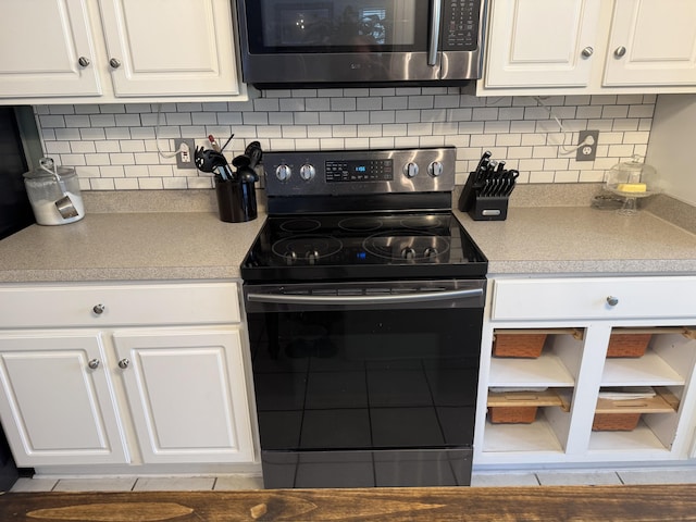 101 Cobblers Glen Ct, Lexington, SC 29072 - kitchen with electric range, stainless steel microwave, backsplash, and white cabinetry