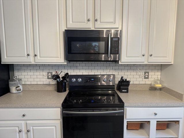 101 Cobblers Glen Ct, Lexington, SC 29072 - kitchen featuring black range with electric cooktop, light countertops, white cabinetry, stainless steel microwave, and tasteful backsplash