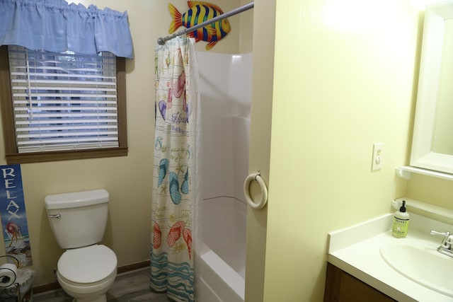 full bathroom with vanity, toilet, hardwood / wood-style floors, and shower / bath combo with shower curtain