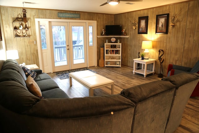 living room with hardwood / wood-style flooring, ceiling fan, and french doors