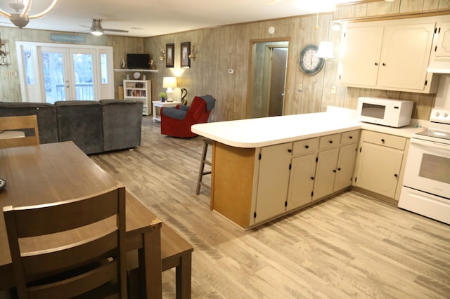 kitchen with white appliances, ceiling fan, kitchen peninsula, french doors, and light wood-type flooring