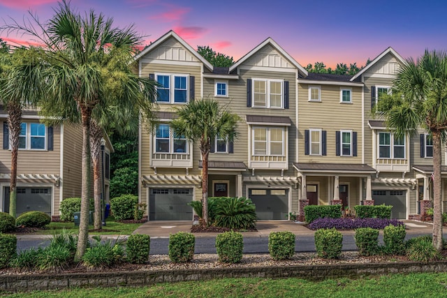1253 Dingle Rd, Mount Pleasant, SC 29466 - view of front of house featuring a garage, board and batten siding, and driveway