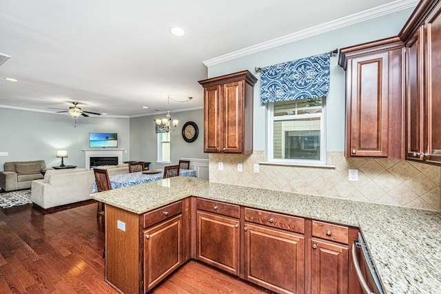 1253 Dingle Rd, Mount Pleasant, SC 29466 - kitchen with a fireplace, crown molding, a peninsula, light wood-style flooring, and ceiling fan
