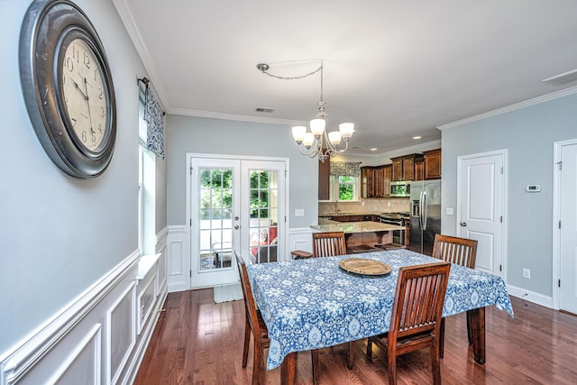 1253 Dingle Rd, Mount Pleasant, SC 29466 - dining area with a chandelier, crown molding, dark wood-style floors, and a wainscoted wall