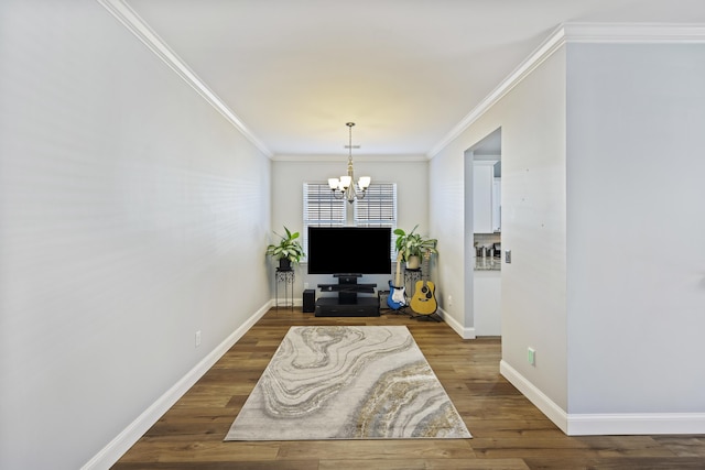 living room featuring ornamental molding, dark wood-type flooring, and an inviting chandelier